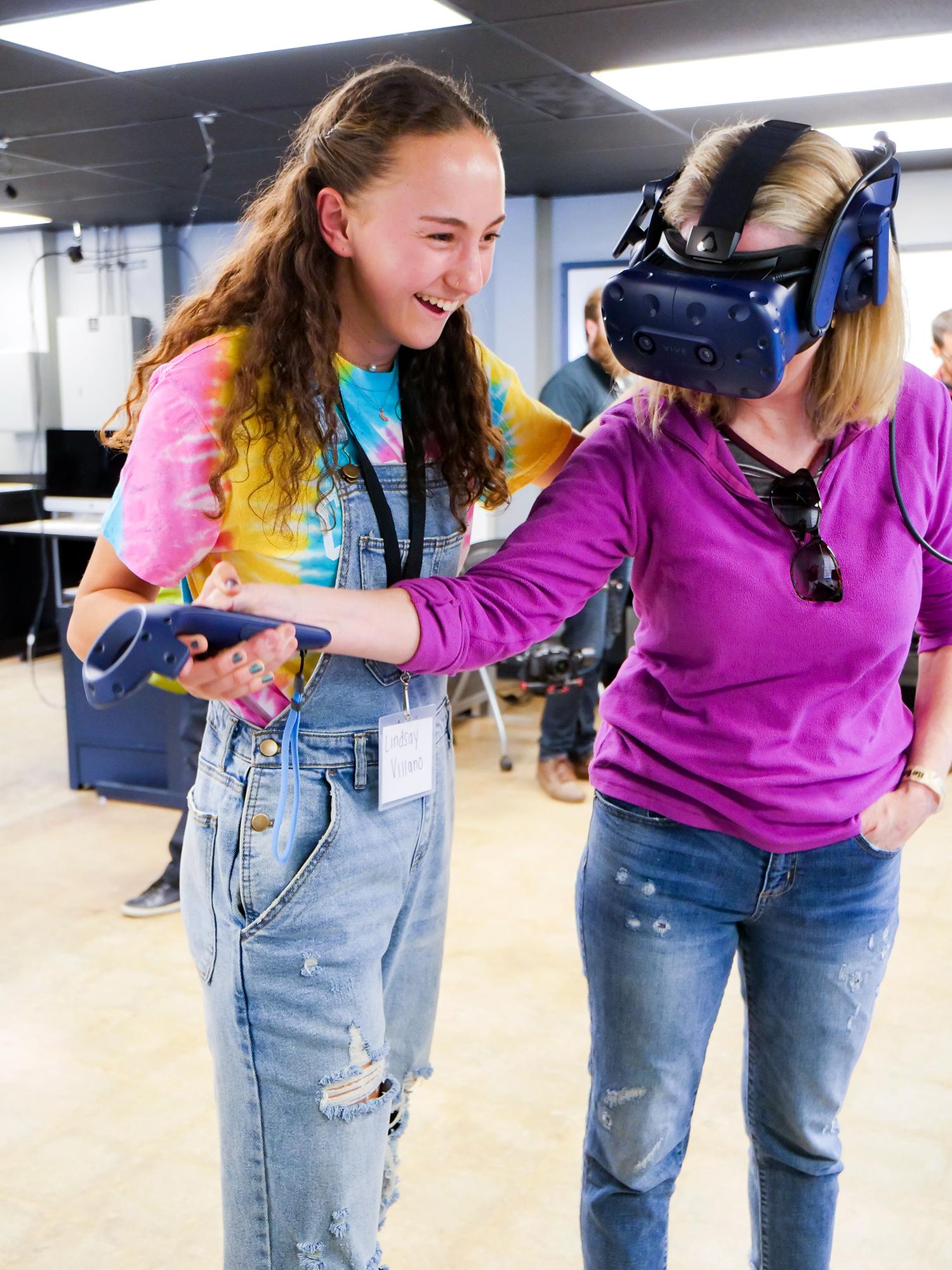 A student and mother check out virtual reality in CMCI's Immersive Media Lab