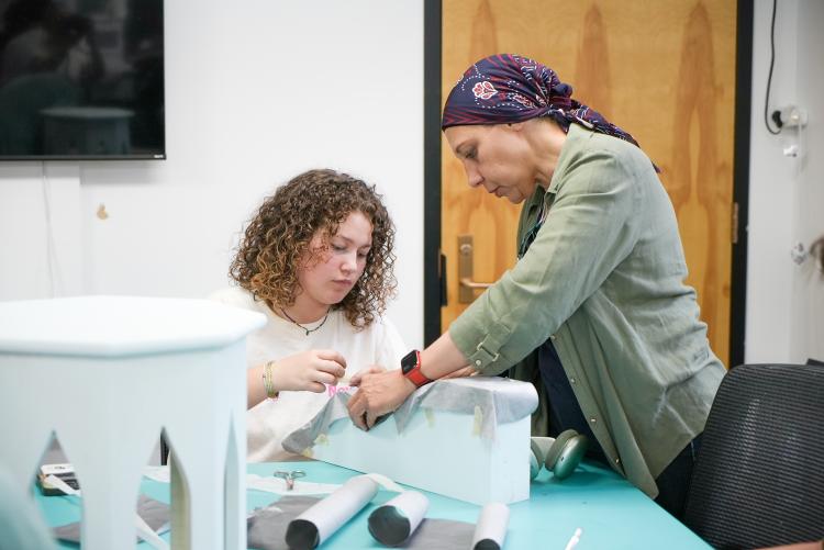 Azza Kamal, right, works with a student on a project to refresh the Boulder Dushanbe Teahouse.