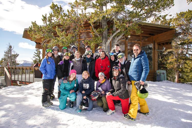 A senior architecture studio poses for a group photo in front of the Lookout Lodge at Eldora Mountain Resort.
