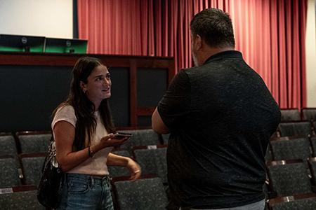 A student interviews an audience member as part of an assignment after the talk.