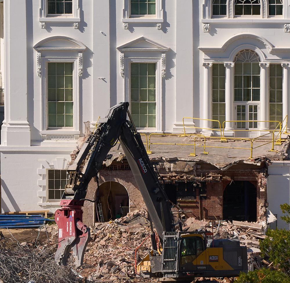 Construction equipment tears through the former East Wing of the White House.