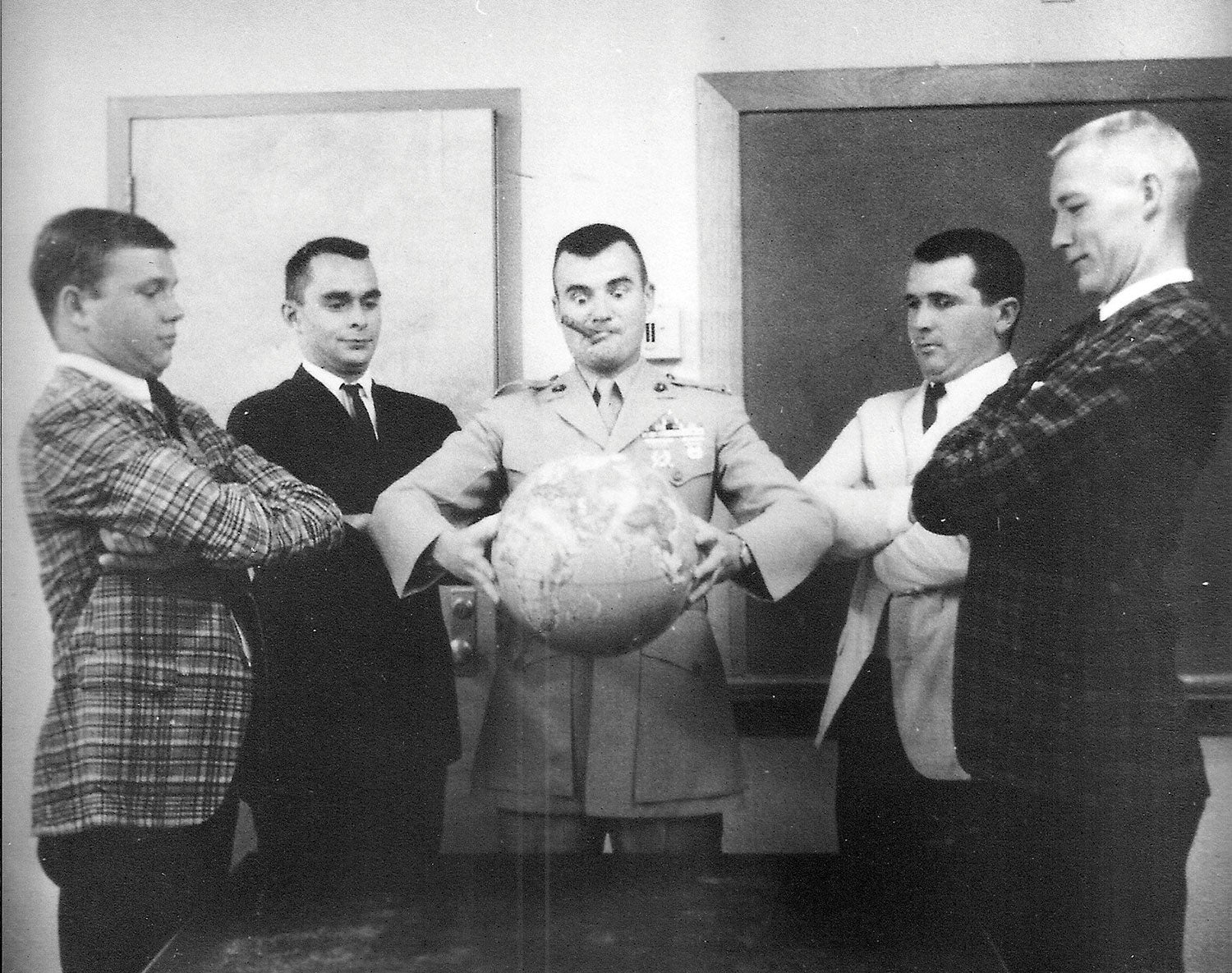 Four young Marines, classes of ’64 and ’65, pictured with General Bernard Trainor