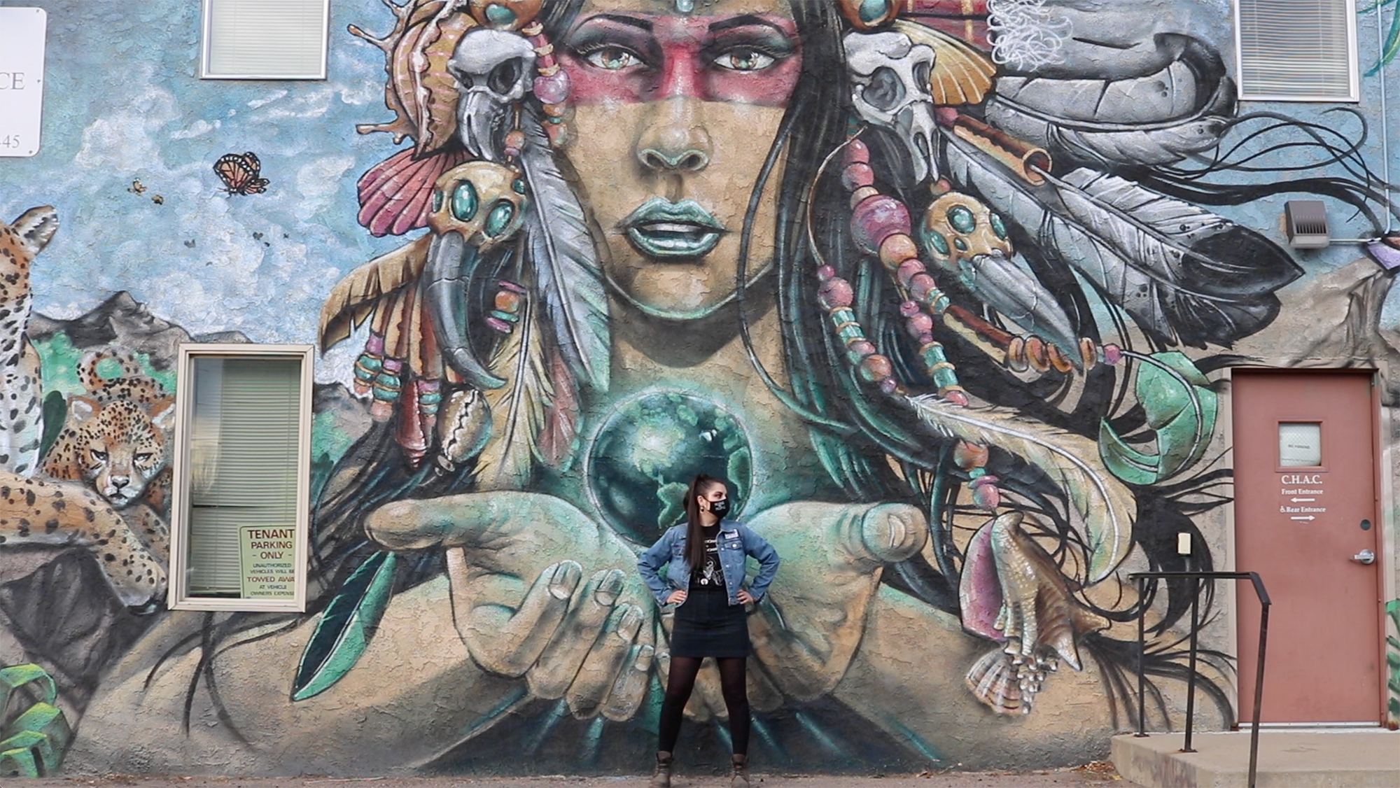  Andrea Fautheree Márquez in front of a mural depicting an Indigenous woman 