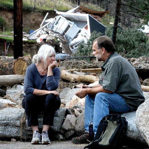 Salina resident Anne Brady talks with FEMA inspector Jerry Williams about her flood-damaged property