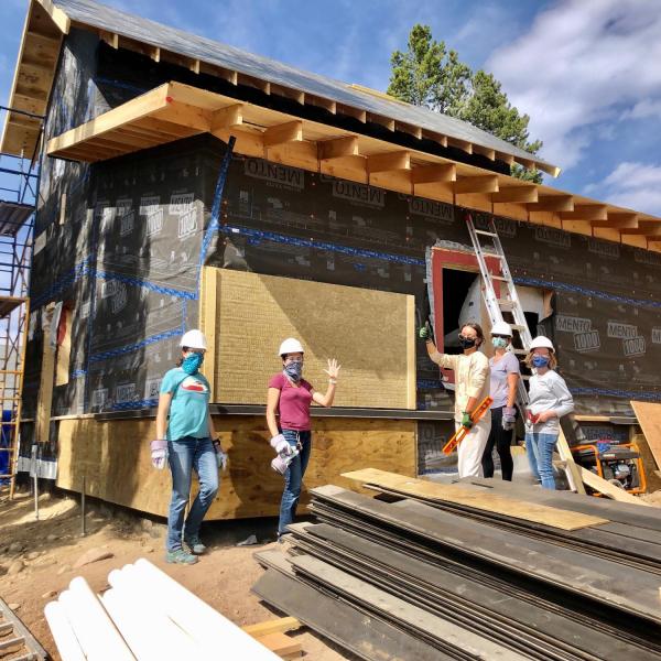 Workers in front of a house