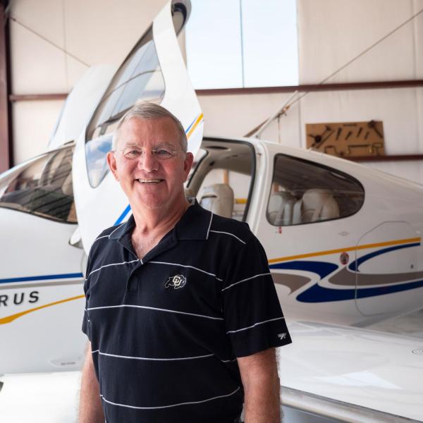 Portrait of Jim Voss in front of his airplanes