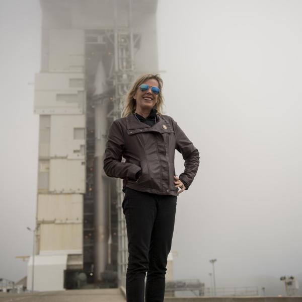 Laurie Cantillo in front of a rocket at NASA