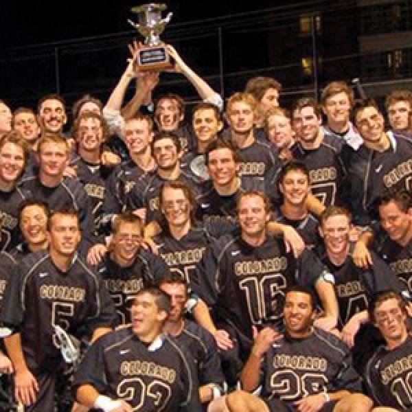 club sports team posing with trophy