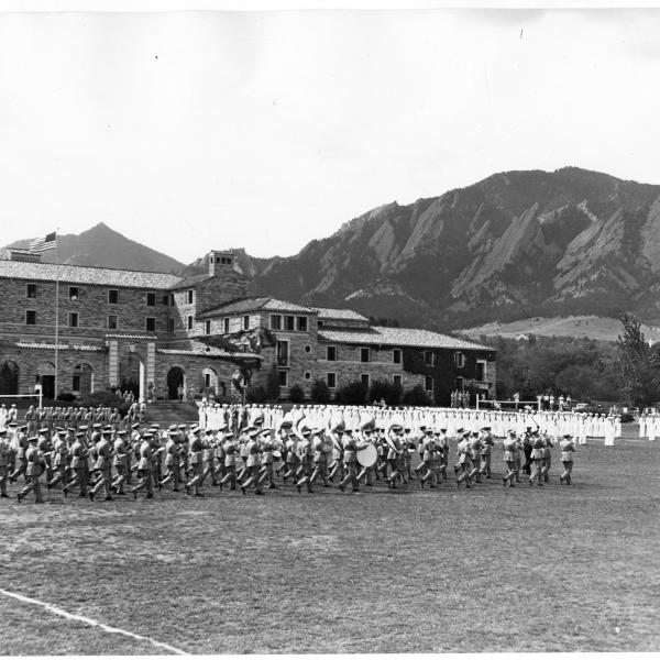 vintage photo of military marching band practicing outside of Baker Hall in 1943
