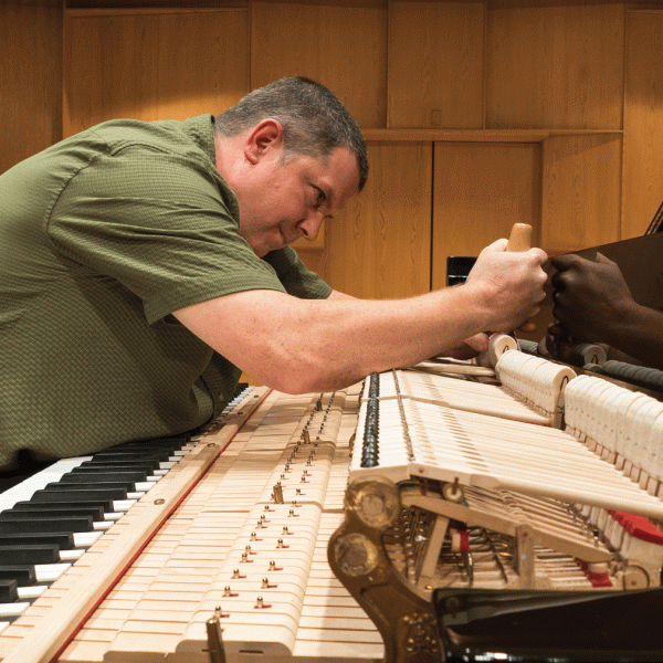 Ted Mulcahey tunes a CU piano