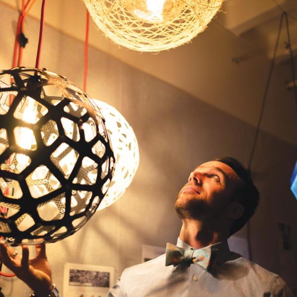 Nicholas Defaria looks at his lamps