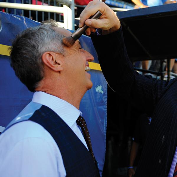 Former Broncos standout John Elway, right, helps Rick Reilly (Jour’81) get ready for Monday Night Football in October 2012.