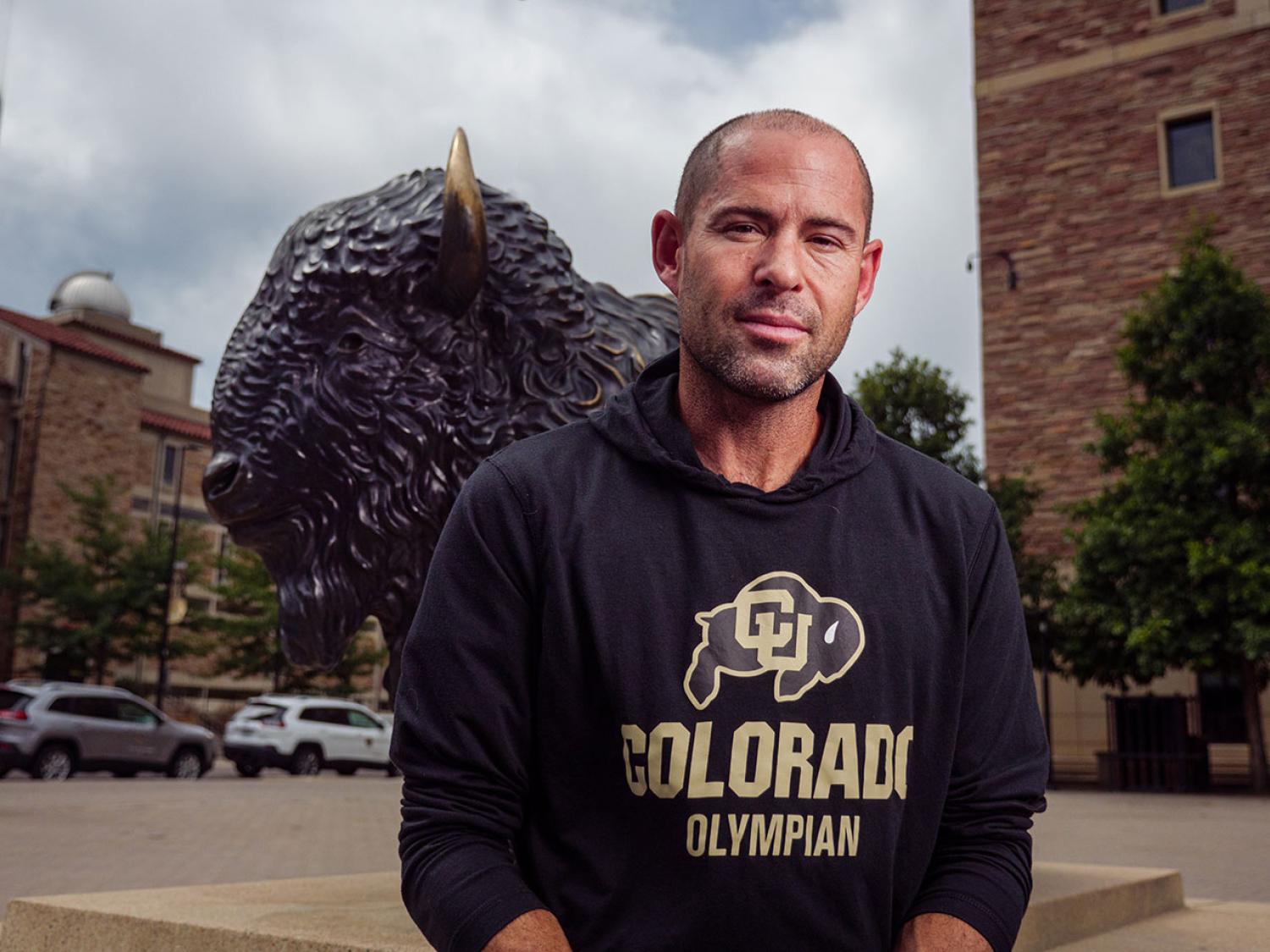 Andrew LeRoy in front of buffalo statue