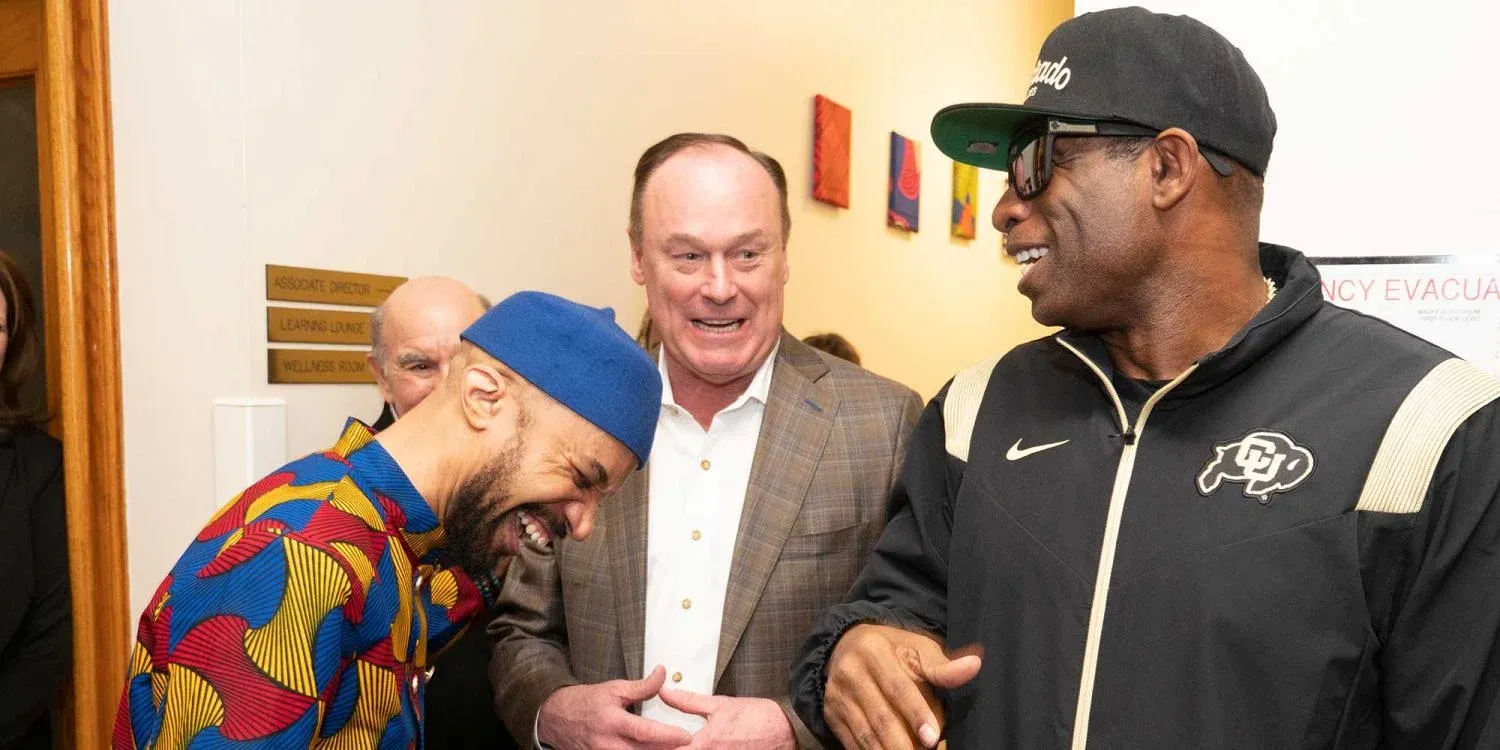 Deion with Athletic Director Rick George