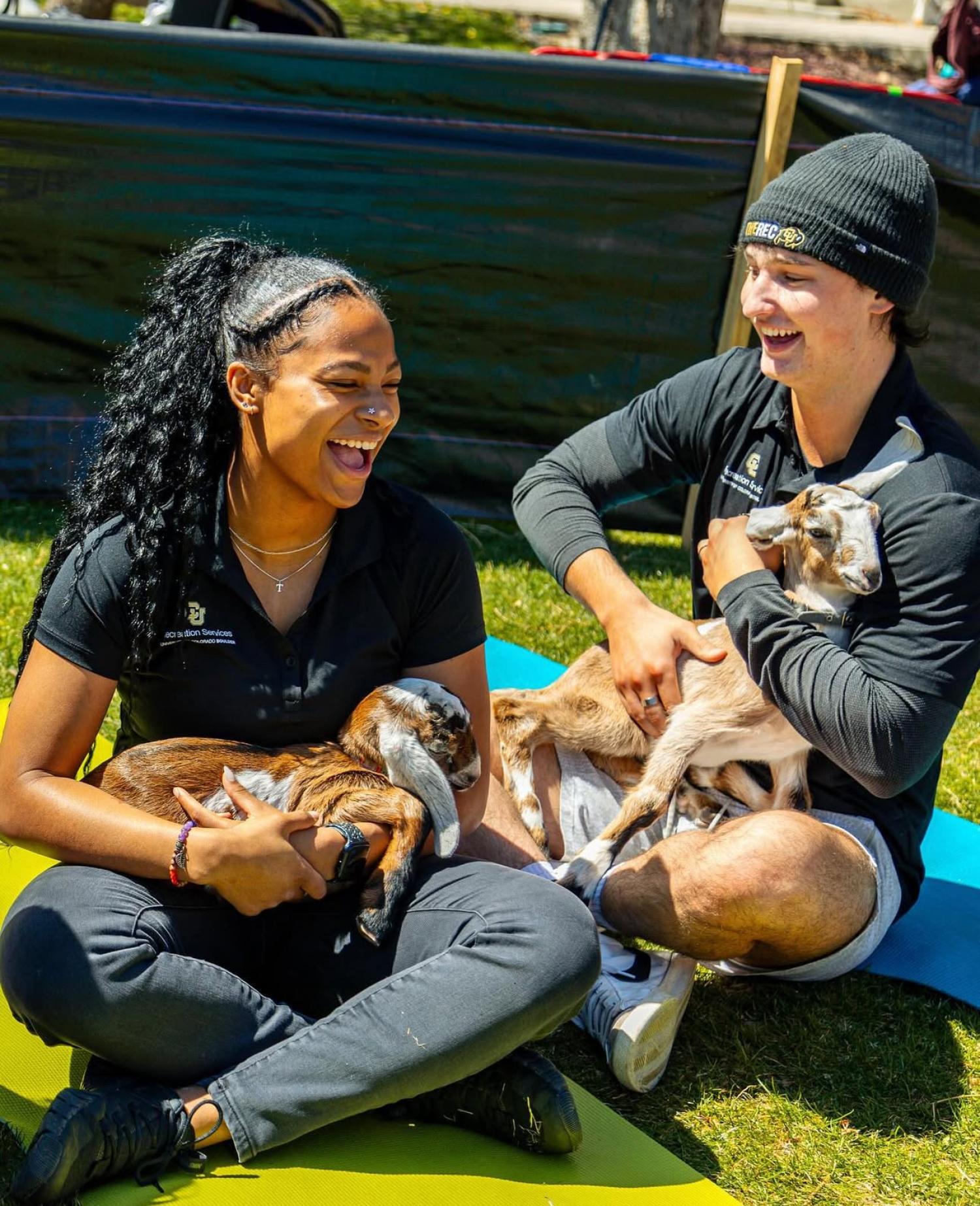 Each spring, the CU Rec Center offers goat yoga sessions to help students unwind during a busy time of year. It is a favorite for many, including for Treyanna Brown, left.