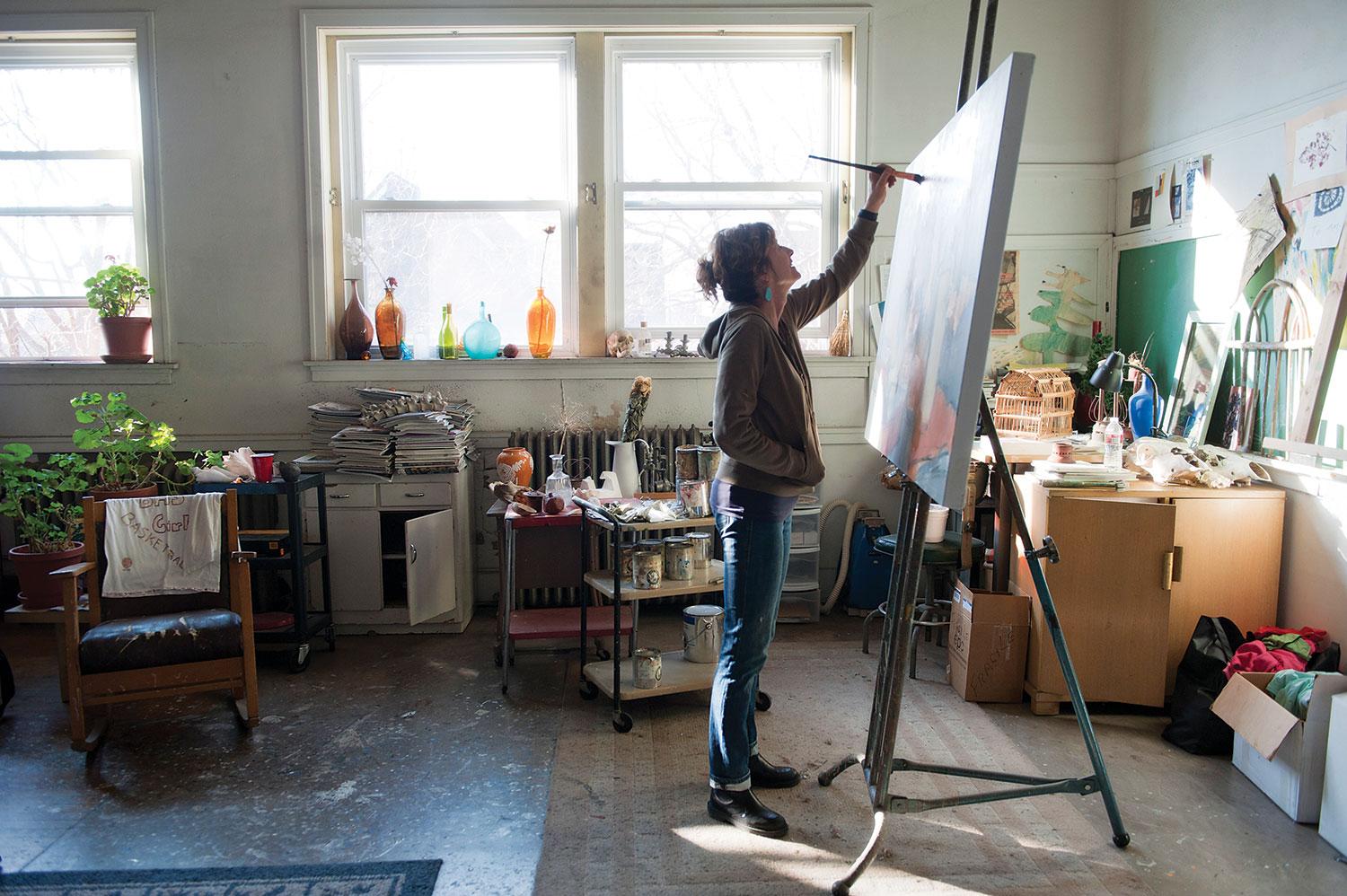 Amy Metier painting in her studio