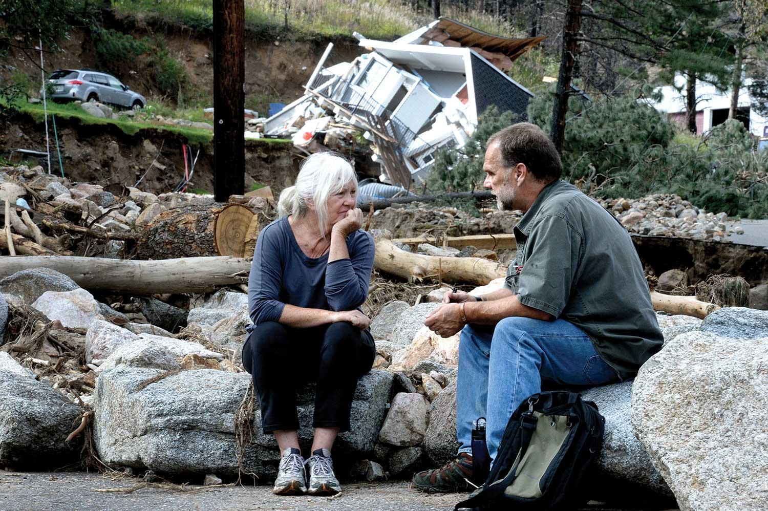 Salina resident Anne Brady talks with FEMA inspector Jerry Williams about her flood-damaged property