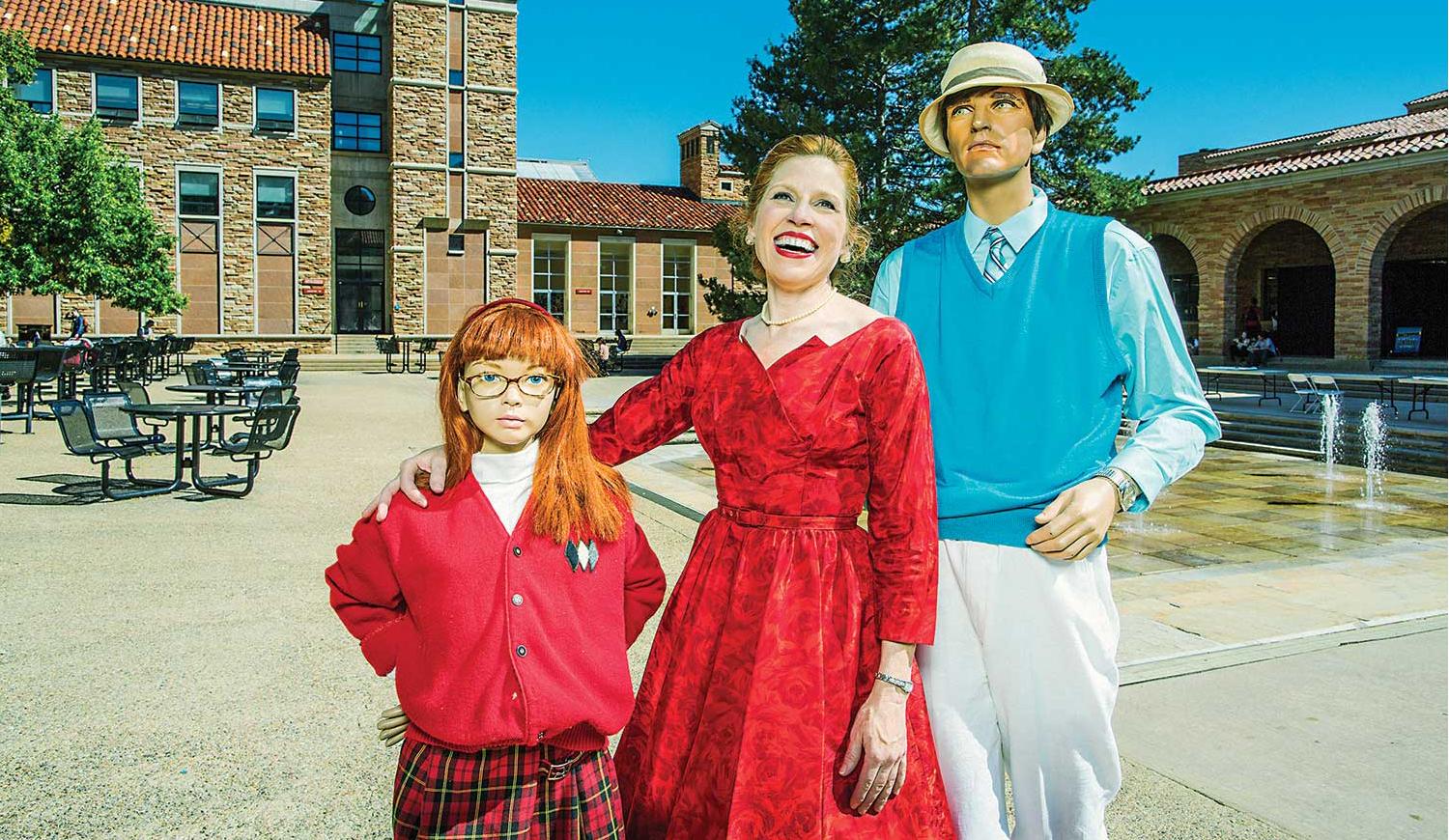 Suzanne Heintz poses with dummy "husband" and "daughter" at the University Memorial Center fountains