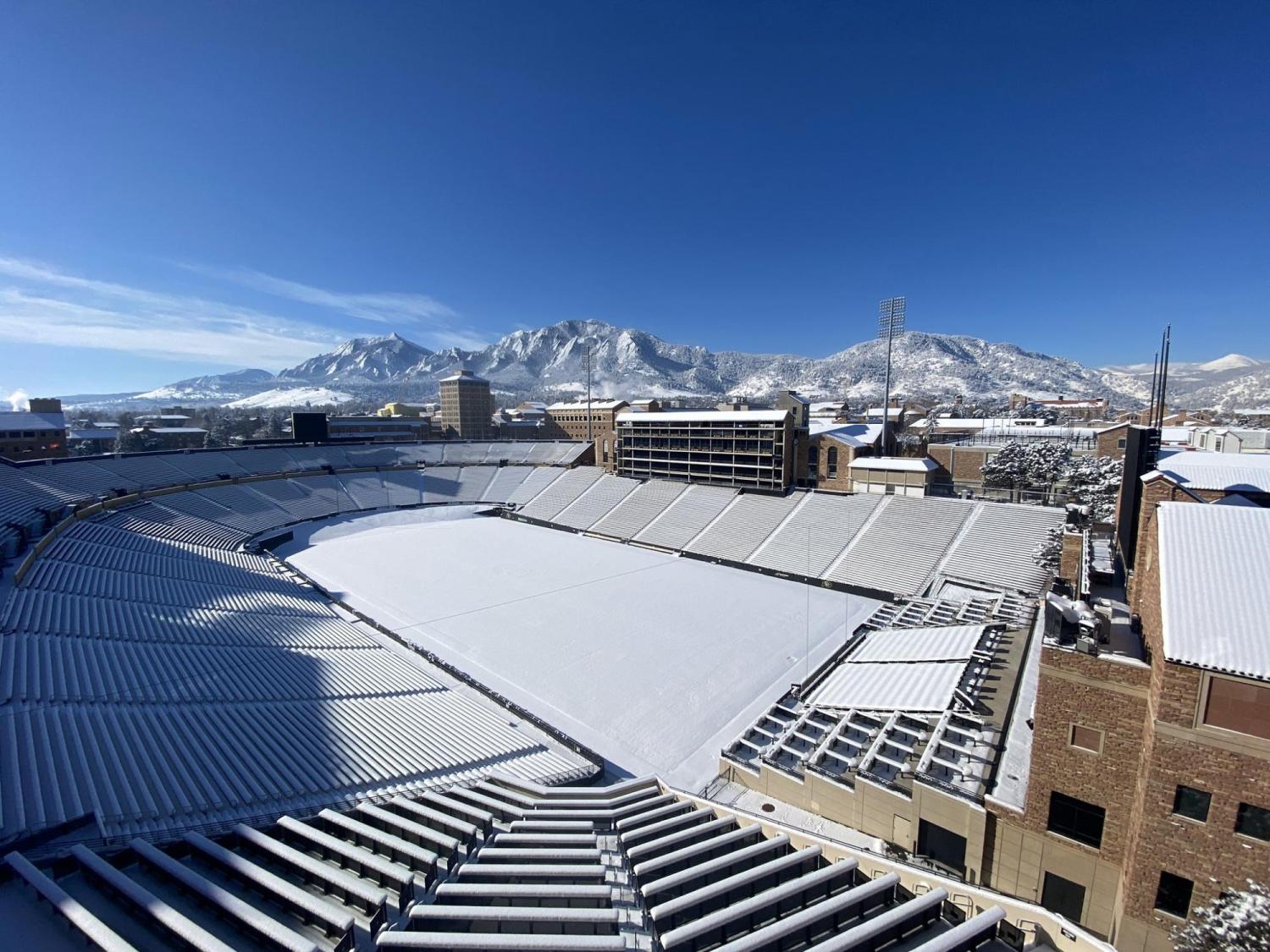 Snowy Folsom Field with Flatirons in the background