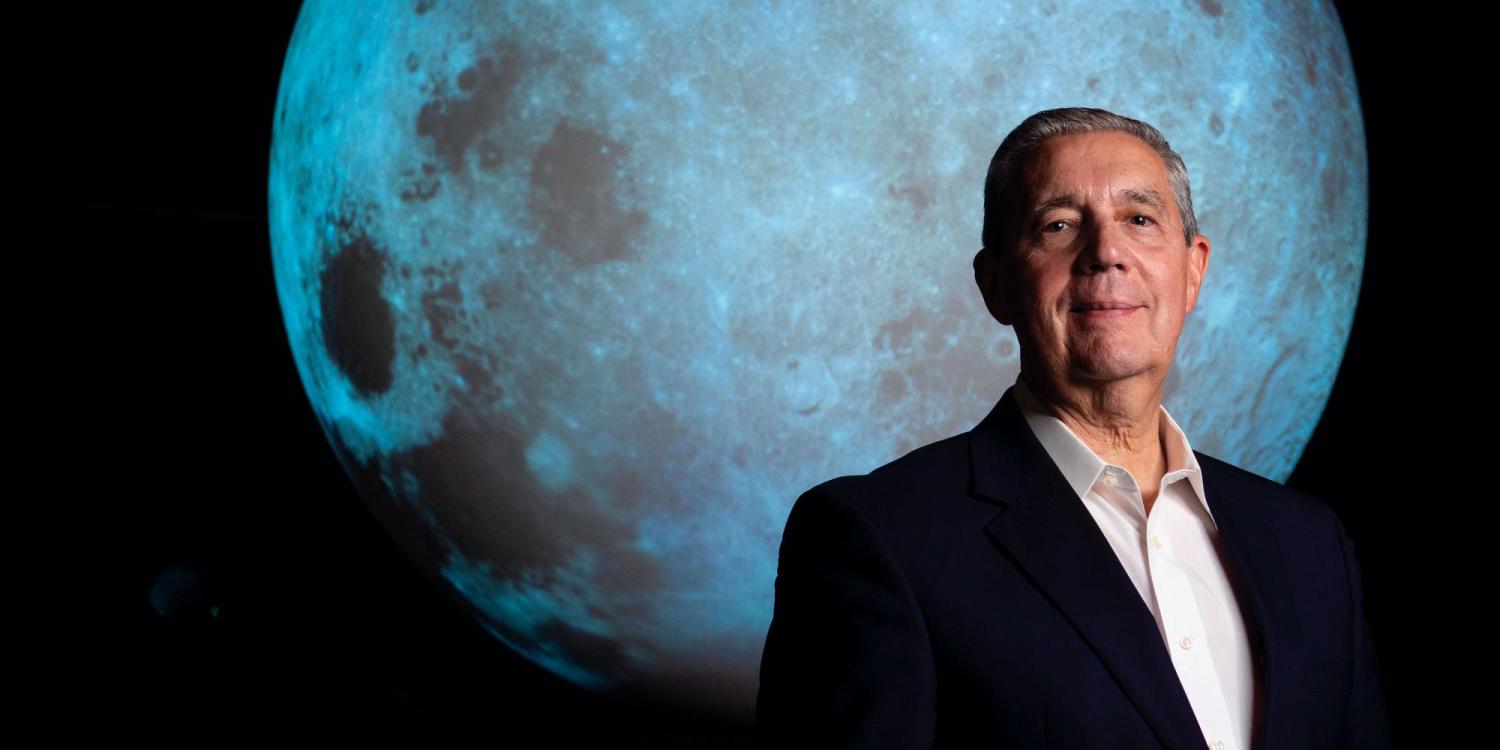 Jack Burns in front of a projection of the moon