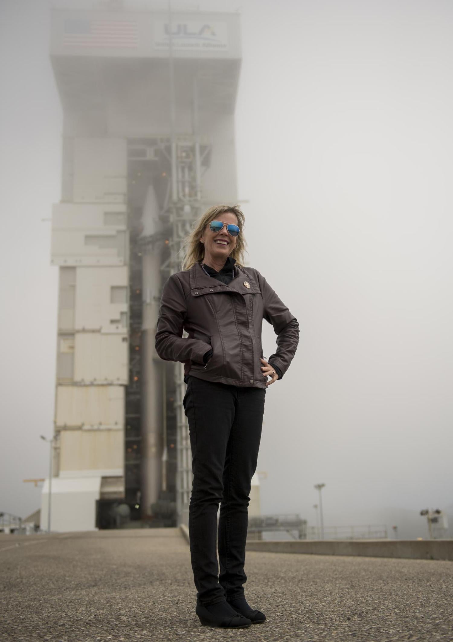 Laurie Cantillo in front of a rocket at NASA