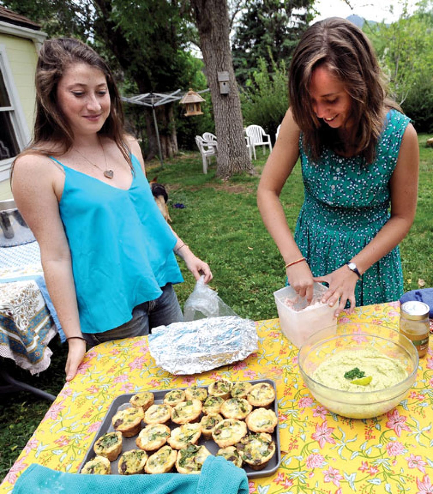 Girls working over serving bowl
