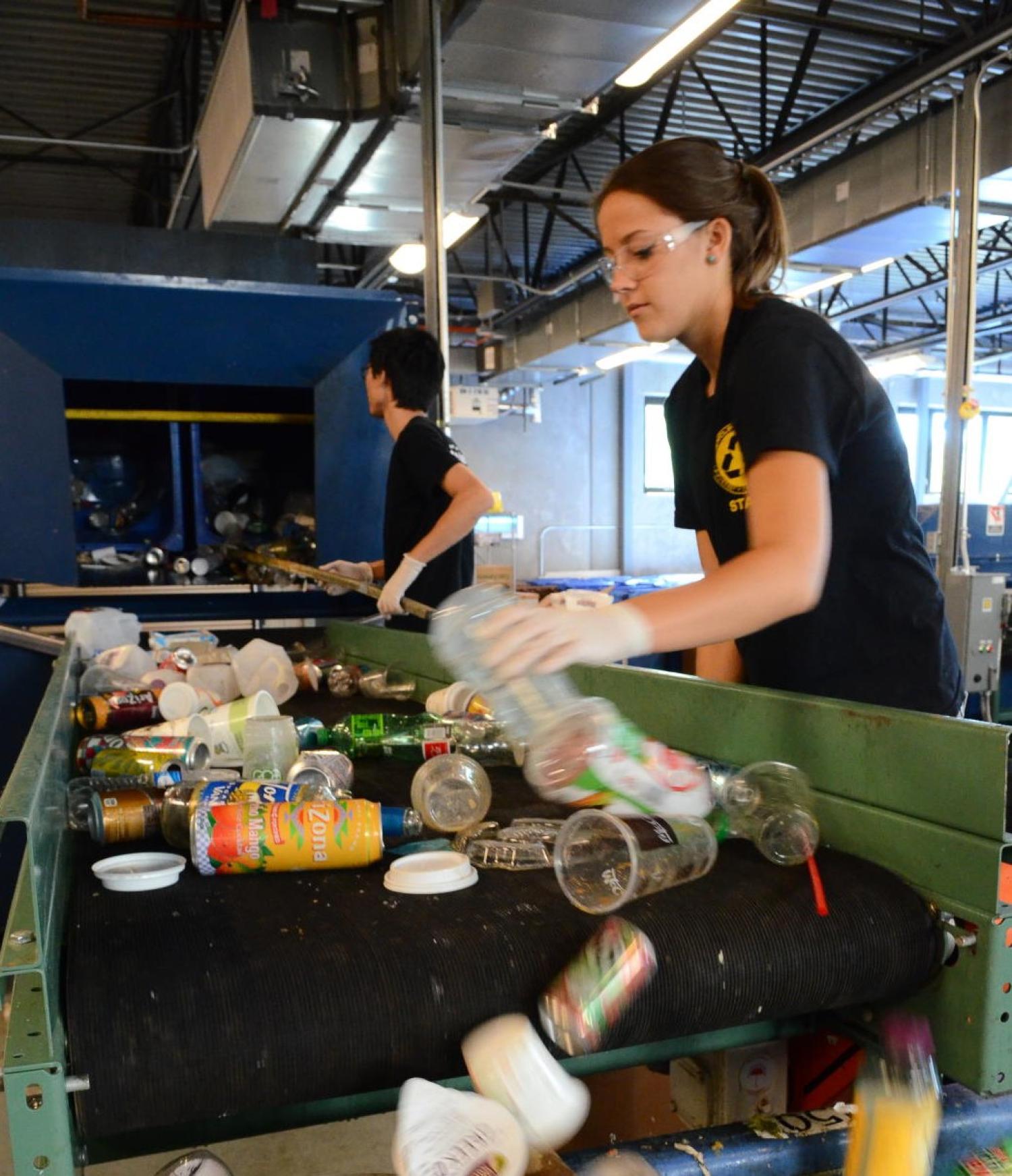 Students separating trash at the CU Recycling Center