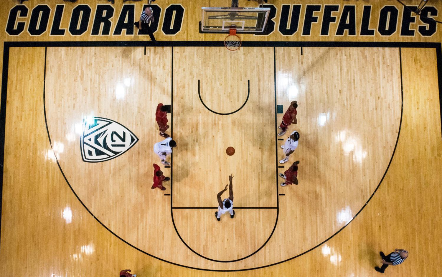 An image taken from above while a CU men’s basketball player shoots a free throw on the court at the CU Events Center.