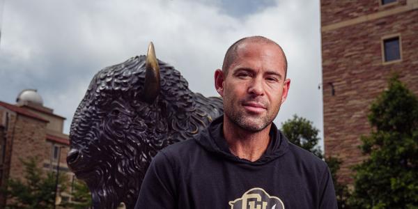 Andrew LeRoy in front of buffalo statue