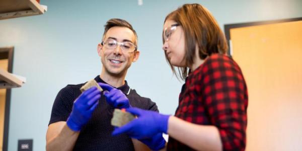 Wil Srubar with a student and holding a living brick