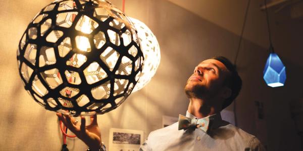 Nicholas Defaria looks at his lamps