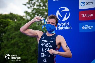 Morgan Pearson hold up his medal. 