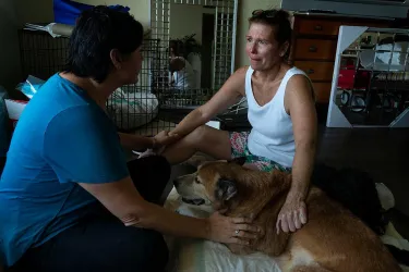Woman saying goodbye to pet dog