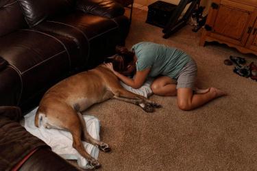 Woman saying goodbye to pet dog