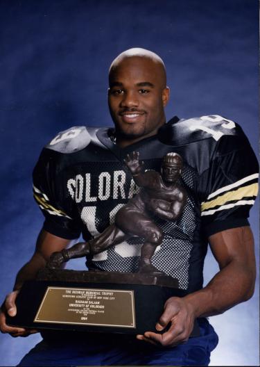 Rashaan Salaam holding the Heisman trophy