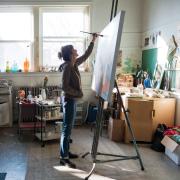 Amy Metier painting in her studio