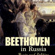 The cover is mostly black with images of people on the left side looking at something that is not pictured. The people are in a theatre and below them is the title: Beethoven in Russia: Music and Politics