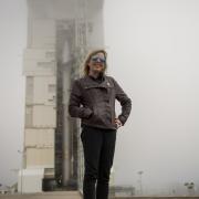 Laurie Cantillo in front of a rocket at NASA