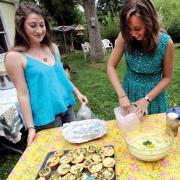 Girls working over serving bowl