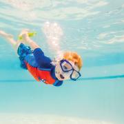 young child swimming underwater