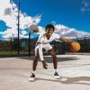 Mya Hollingshead poses for a picture holding a basketball