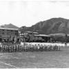 vintage photo of military marching band practicing outside of Baker Hall in 1943