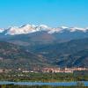 CU's campus stands out against the front range, Rocky mountains, and clear blue sky.