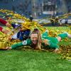 soccer goalie J.J. Tompkins celebrates on the soccer field with gold streamers around her