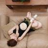 woman on couch eating popcorn holding remote