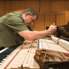 Ted Mulcahey tunes a CU piano