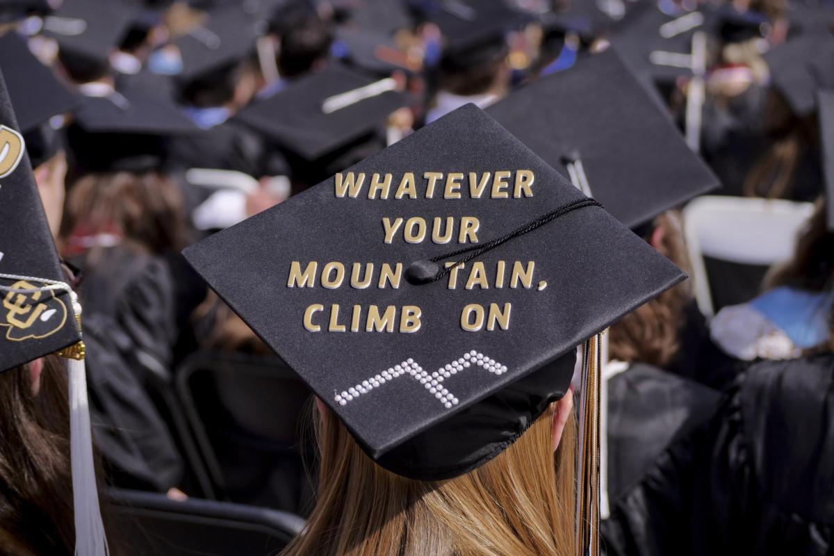 A graduation cap that reads "Whatever your mountain, climb on"