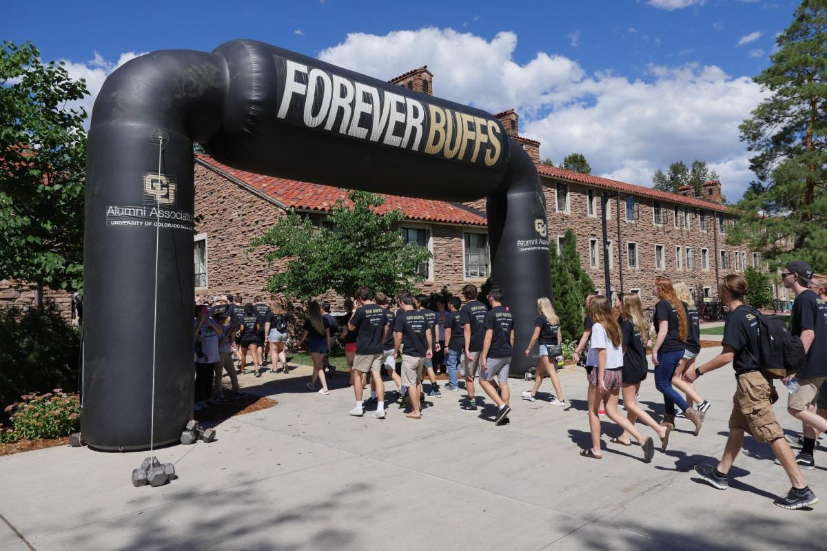 Students walking under a Forever Buffs banner.