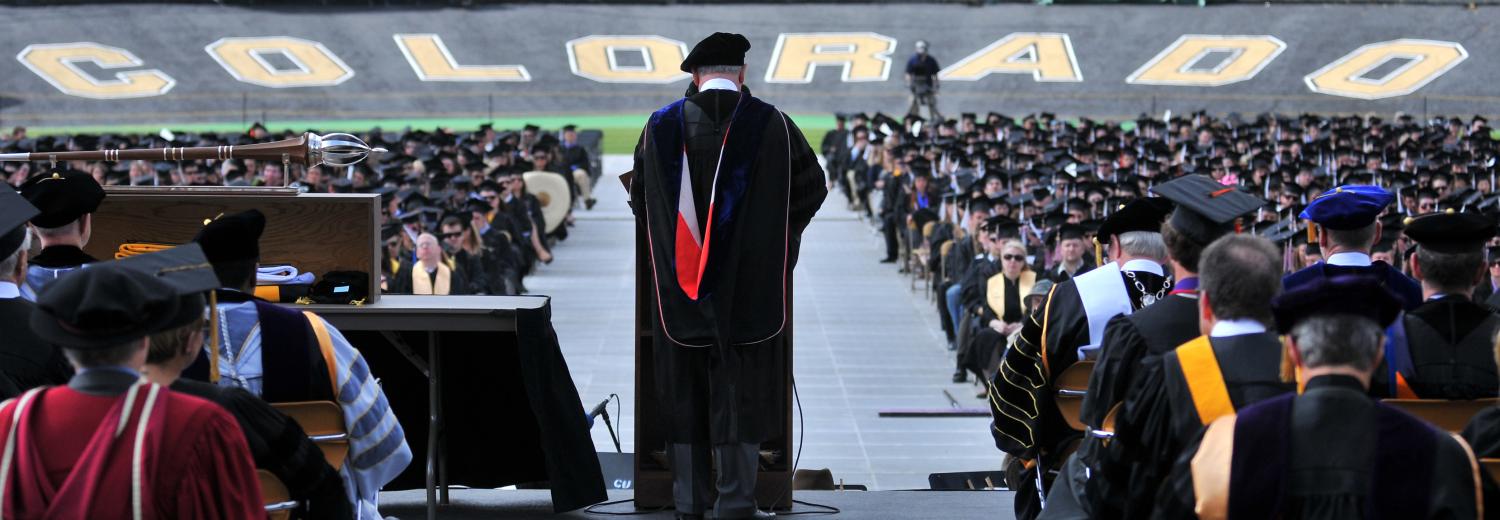 Chancellor Phil DiStefano addressing graduates in Folsom Field