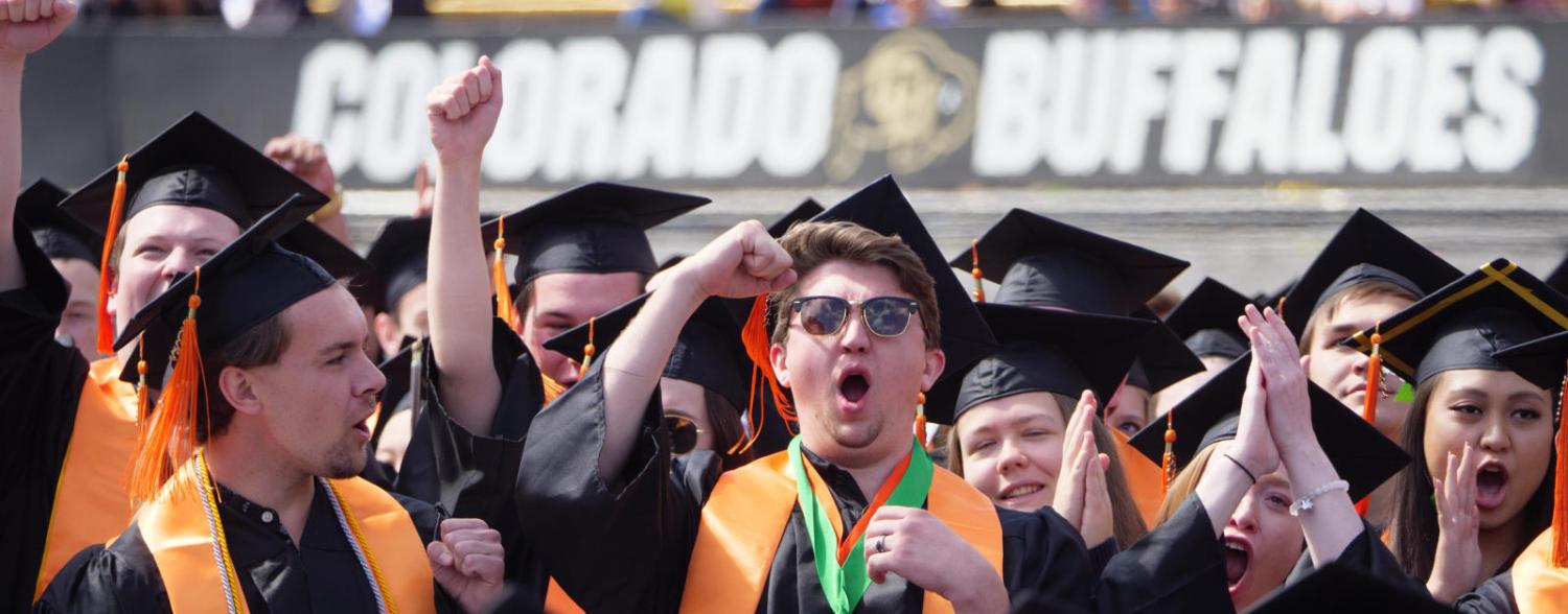 Newly graduated students celebrating on Folsom Field